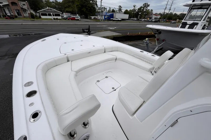 Slide: The Image of 2026 Tidewater 2500 Carolina Bay boat with white seating and spacious deck. - 12