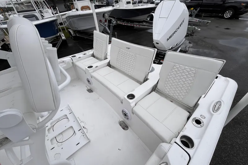 Slide: The Image of 2026 Tidewater 2500 Carolina Bay boat interior with white seating and Mercury engine. - 13