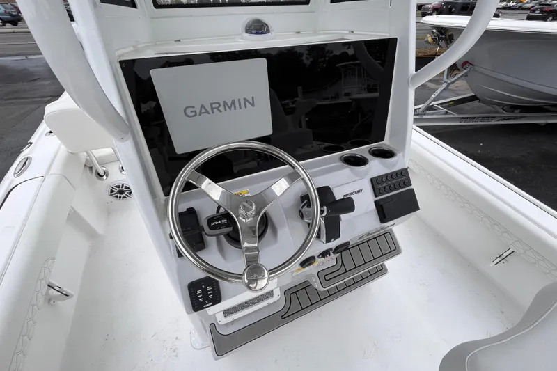 Slide: The Image of 2026 Tidewater 2500 Carolina Bay boat console with Garmin navigation and Mercury controls. - 15