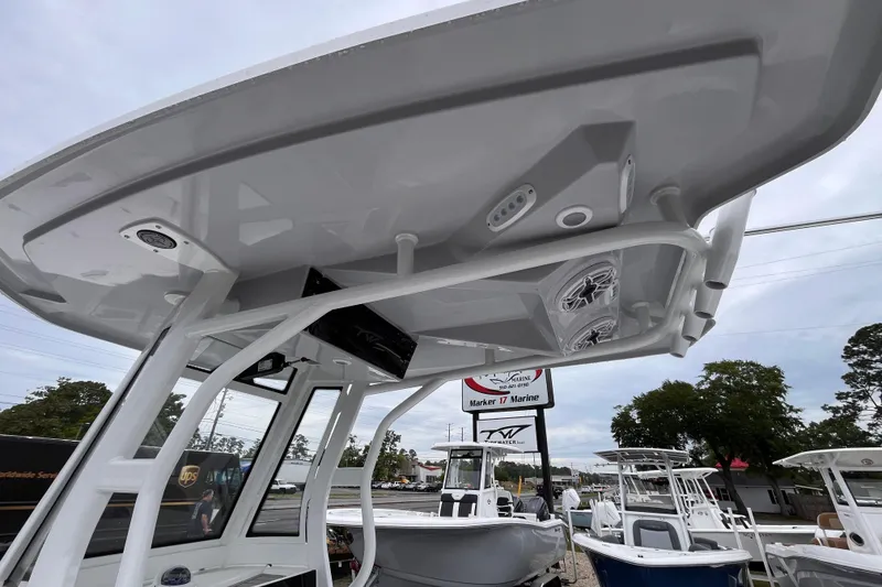 Slide: The Image of 2026 Tidewater 2500 Carolina Bay boat with T-top and electronics at a marine dealership. - 16