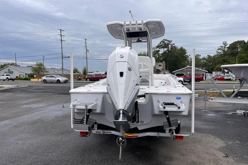 Slide: The Image of 2026 Tidewater 2500 Carolina Bay boat, rear view, parked outdoors on a cloudy day. - 3