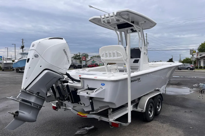 Slide: The Image of 2026 Tidewater 2500 Carolina Bay boat with Mercury outboard engine on a trailer. - 4