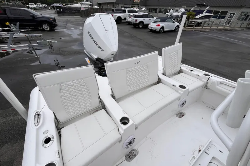Slide: The Image of 2026 Tidewater 2500 Carolina Bay boat with white seating and Mercury outboard motor. - 6