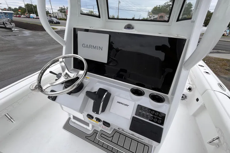 Slide: The Image of 2026 Tidewater 2500 Carolina Bay boat console with Garmin navigation and Mercury controls. - 8