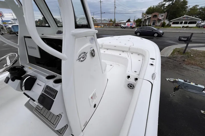 Slide: The Image of 2026 Tidewater 2500 Carolina Bay boat with Garmin electronics, parked near a road. - 9