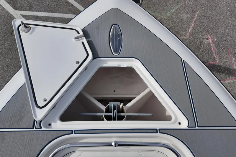 Slide: The Image of 2024 Contender 39 ST boat anchor compartment with open hatch, showcasing sleek design. - 10