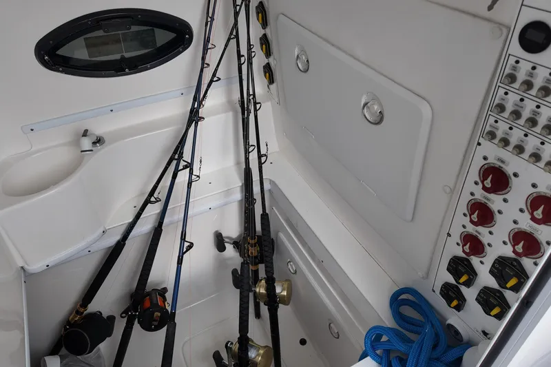 Slide: The Image of 2024 Contender 39 ST boat interior with fishing rods and control panel. - 14