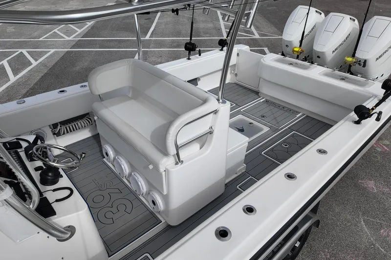 Slide: The Image of 2024 Contender 39 ST boat interior with seating, steering wheel, and triple Mercury engines. - 15