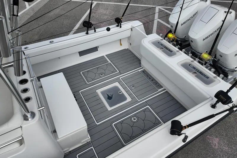 Slide: The Image of 2024 Contender 39 ST boat deck with fishing rods and Mercury engines. - 18