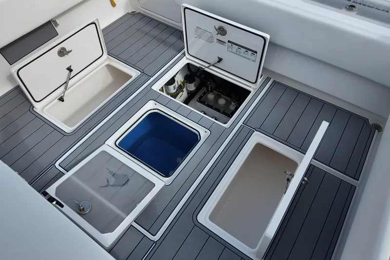 Slide: The Image of 2024 Contender 39 ST boat deck with open storage compartments and sleek design. - 19