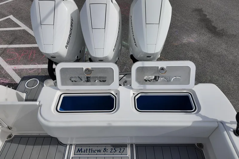 Slide: The Image of 2024 Contender 39 ST boat with Mercury engines and dual livewells, featuring Matthew 8:25-27 inscription. - 20