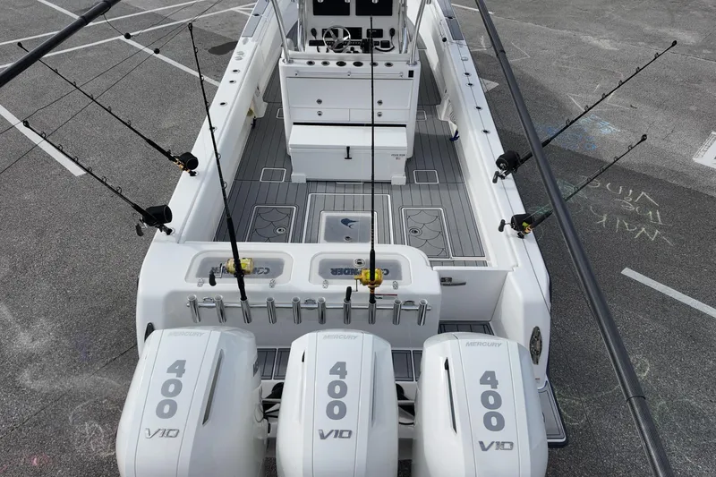 Slide: The Image of 2024 Contender 39 ST boat with triple Mercury 400 V10 engines and fishing rods. - 23