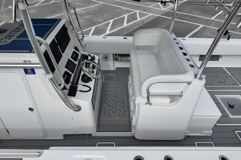 Slide: The Image of 2024 Contender 39 ST boat interior with helm, seating, and modern controls. - 25