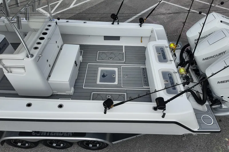Slide: The Image of 2024 Contender 39 ST boat deck with fishing rods and Mercury engines. - 26