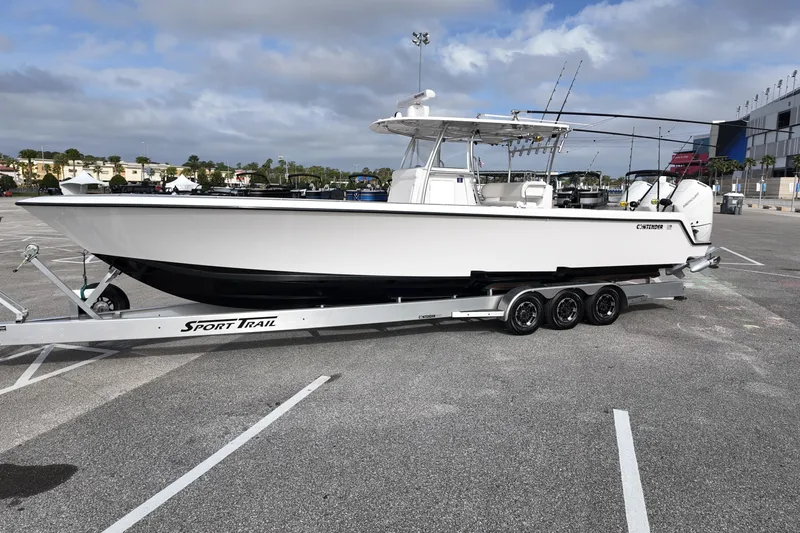 Slide: The Image of 2024 Contender 39 ST boat on Sport Trail trailer in parking lot. - 3