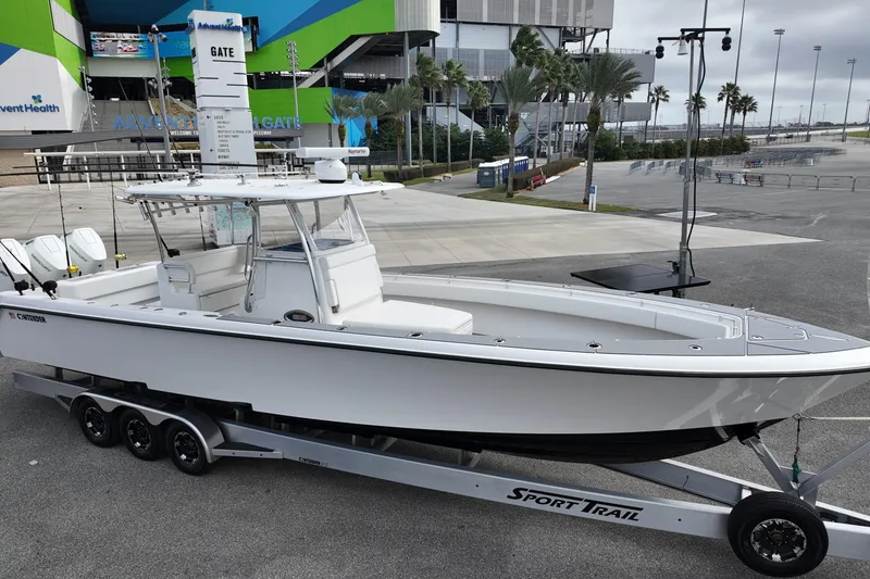Slide: The Image of 2024 Contender 39 ST boat on trailer at event venue, featuring sleek design and modern amenities. - 4