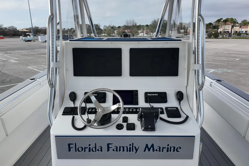 Slide: The Image of 2024 Contender 39 ST boat console with steering wheel and navigation equipment. - 8