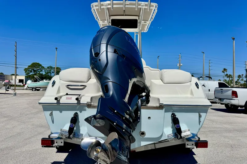 Slide: The Image of 2026 Key West 203 FS boat with powerful outboard motor in sunny parking lot. - 10