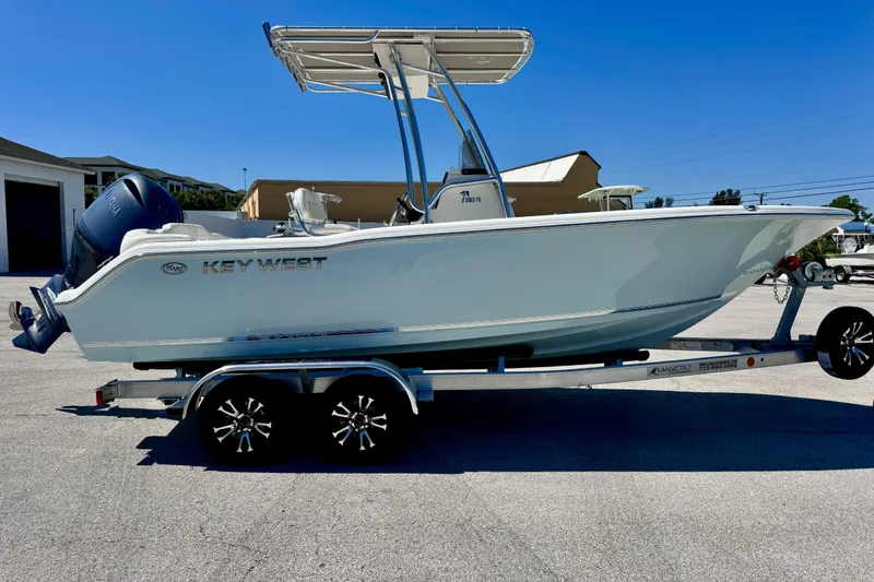 Slide: The Image of 2026 Key West 203 FS boat on trailer, featuring sleek design and modern outboard motor. - 11