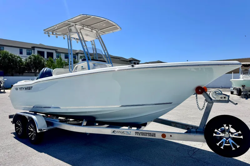 Slide: The Image of 2026 Key West 203 FS boat on trailer under clear blue sky. - 13
