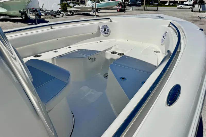 Slide: The Image of 2026 Key West 203 FS boat interior with seating and cup holders in a marina setting. - 14