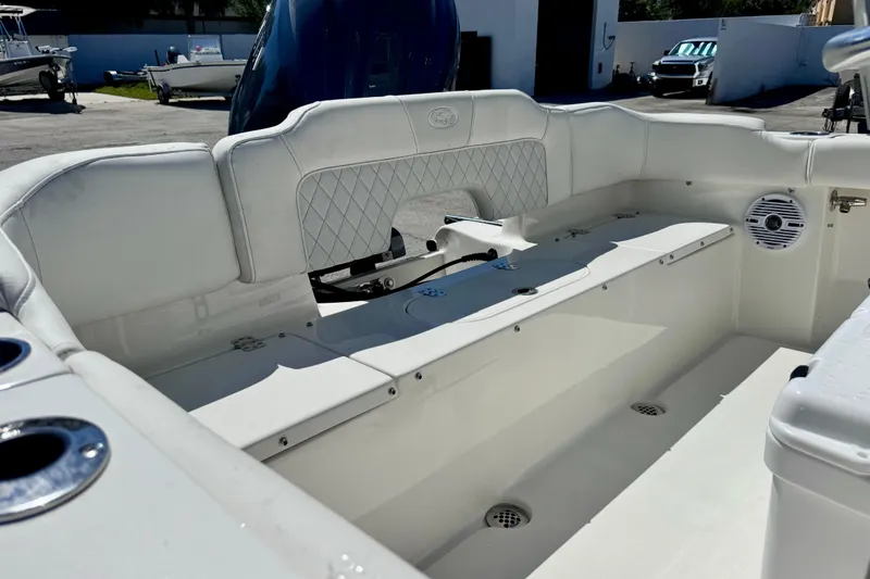 Slide: The Image of 2026 Key West 203 FS boat interior with white seating and storage compartments. - 19