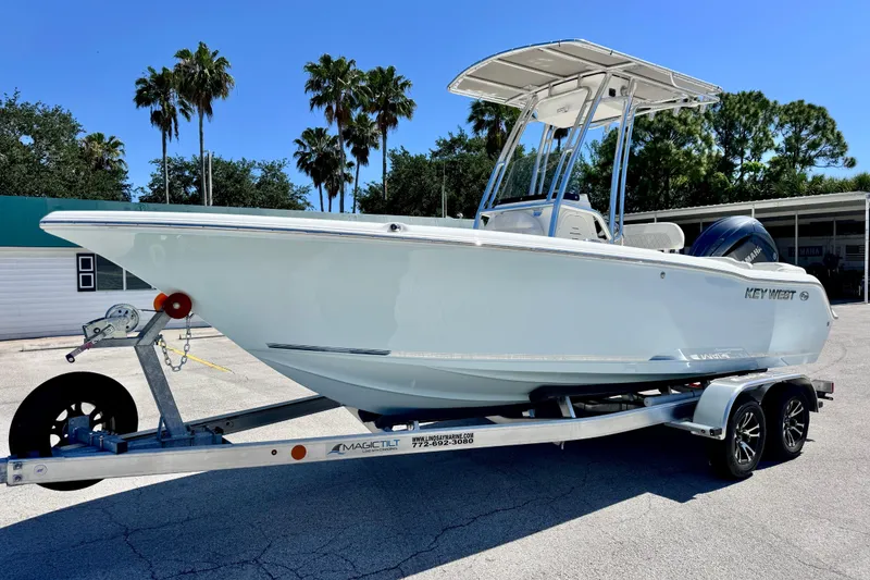 The Image of 2026 Key West 203 FS boat on trailer, parked outdoors under clear blue sky. - 7