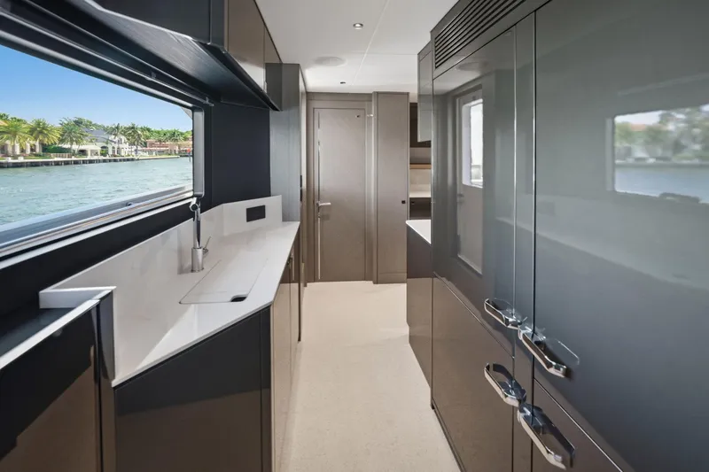 Slide: The Image of Luxurious interior of 2024 Sunseeker 100 Yacht with sleek cabinetry and waterfront view. - 12