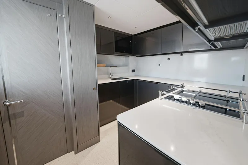 Slide: The Image of Modern kitchen interior on 2024 Sunseeker 100 Yacht, featuring sleek cabinetry and appliances. - 13