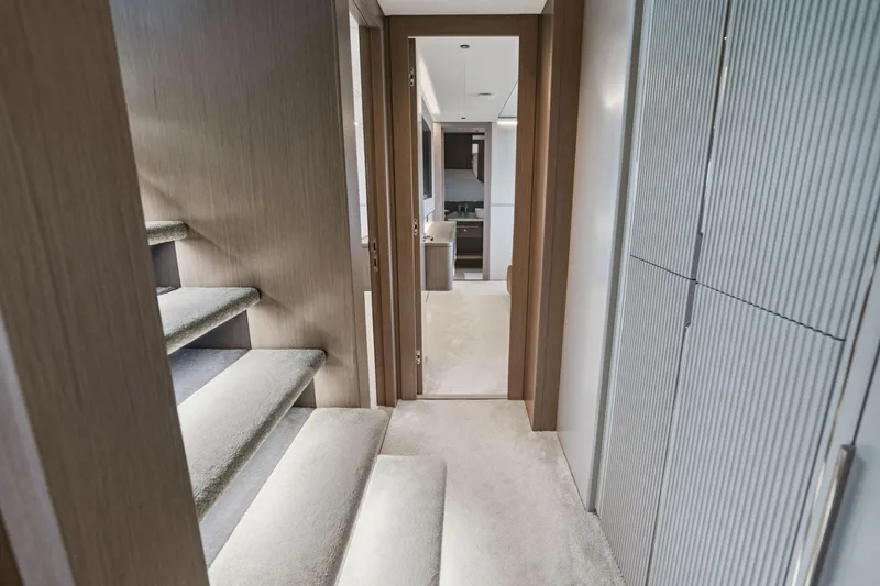 Slide: The Image of Interior hallway of 2024 Sunseeker 100 Yacht with modern design and carpeted stairs. - 19