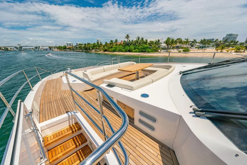 Slide: The Image of Luxurious 2024 Sunseeker 100 Yacht with spacious deck and scenic coastal view. - 29
