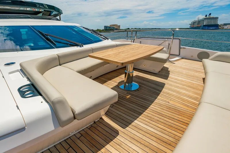Slide: The Image of Luxurious 2024 Sunseeker 100 Yacht deck with elegant seating and wooden table. - 31