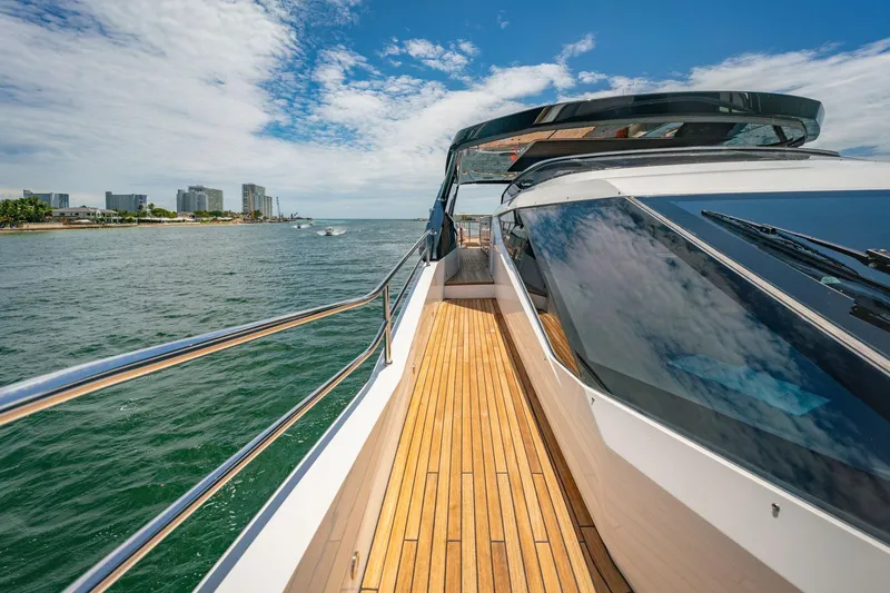 Slide: The Image of 2024 Sunseeker 100 Yacht cruising near coastline under blue sky. - 34