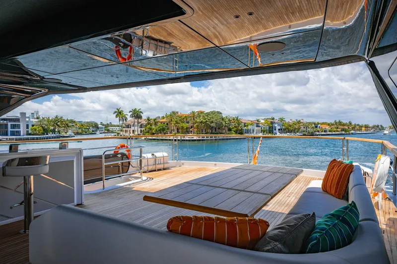 Slide: The Image of Luxurious 2024 Sunseeker 100 Yacht deck with waterfront view and plush seating. - 38