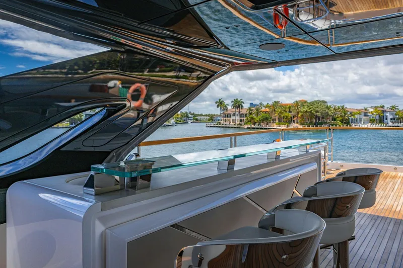 Slide: The Image of Luxurious Sunseeker 100 Yacht 2024 with sleek bar and waterfront view. - 39
