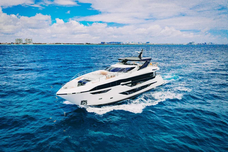 Slide: The Image of Luxurious 2024 Sunseeker 100 Yacht cruising on vibrant blue ocean waters. - 4