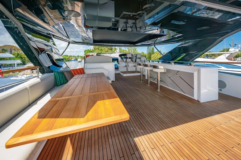 Slide: The Image of Luxurious Sunseeker 100 Yacht 2024 deck with elegant seating and wooden table. - 40