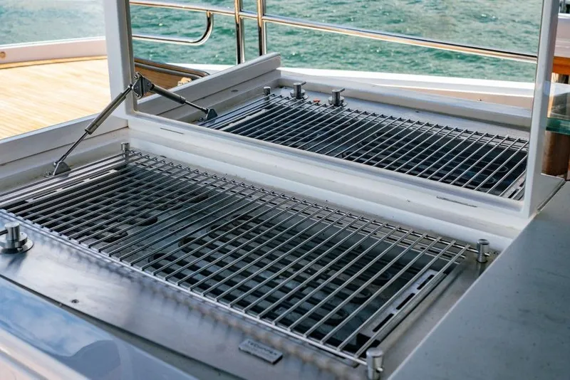 Slide: The Image of Outdoor grill on the 2024 Sunseeker 100 Yacht, overlooking the ocean. - 41