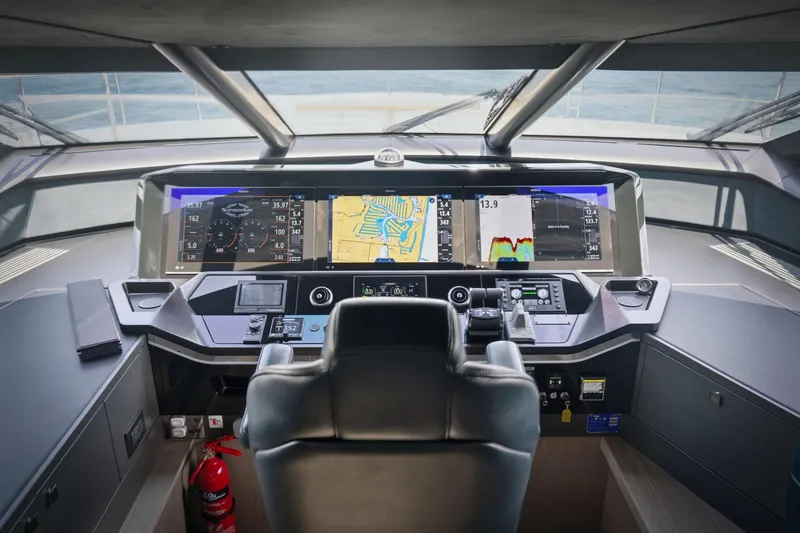 Slide: The Image of Cockpit of 2024 Sunseeker 100 Yacht with advanced navigation displays and controls. - 43