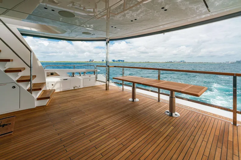 Slide: The Image of Luxurious 2024 Sunseeker 100 Yacht deck with wooden flooring and ocean view. - 7