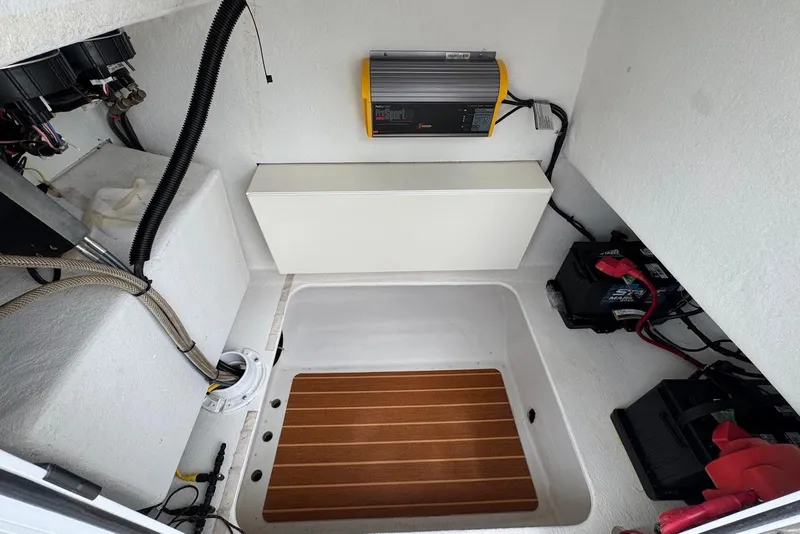 Slide: The Image of 2014 Steiger Craft 21 Tournament boat interior with electrical components and battery setup. - 10