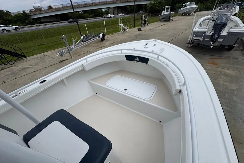 Slide: The Image of 2014 Steiger Craft 21 Tournament boat, white interior, parked on concrete near highway. - 11