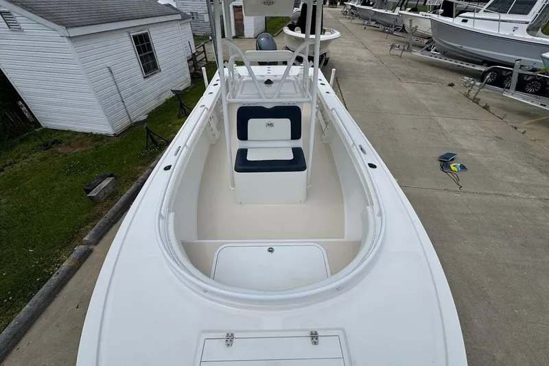 Slide: The Image of 2014 Steiger Craft 21 Tournament boat, white interior, docked near a shed. - 14
