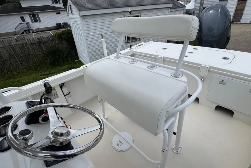 Slide: The Image of 2014 Steiger Craft 21 Tournament boat interior with steering wheel and seating. - 16