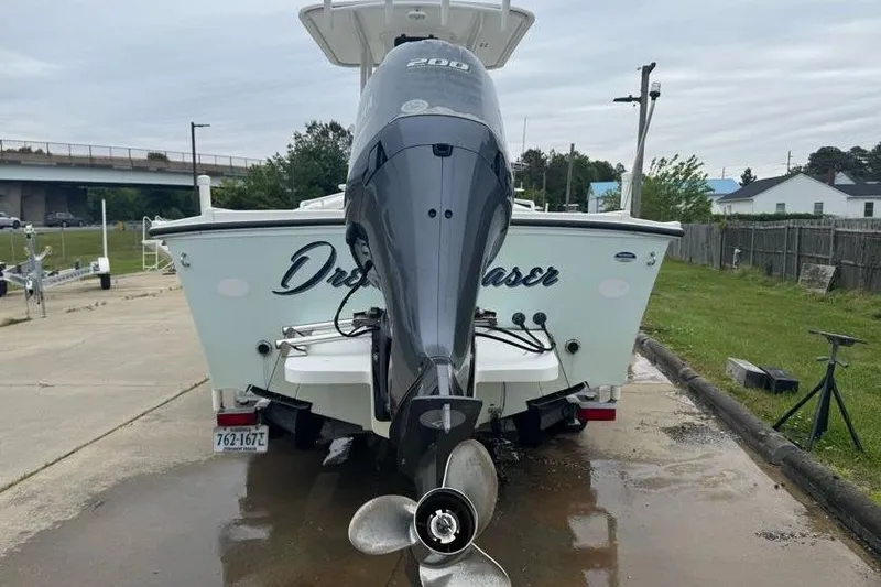 Slide: The Image of 2014 Steiger Craft 21 Tournament boat with powerful outboard motor, parked on a trailer. - 3