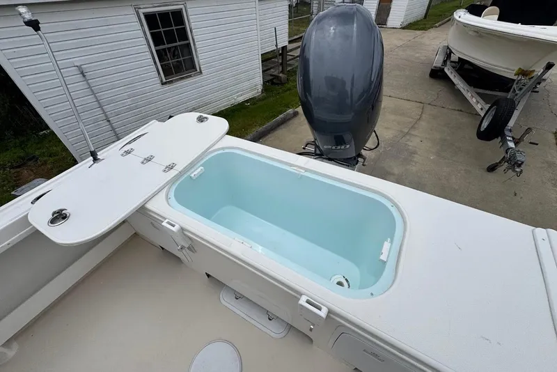 Slide: The Image of 2014 Steiger Craft 21 Tournament boat with open storage compartment and outboard motor. - 7