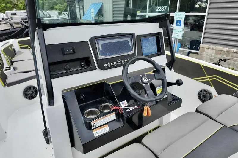 Slide: The Image of 2020 Scarab 255 ID boat dashboard with steering wheel and control panels. - 11