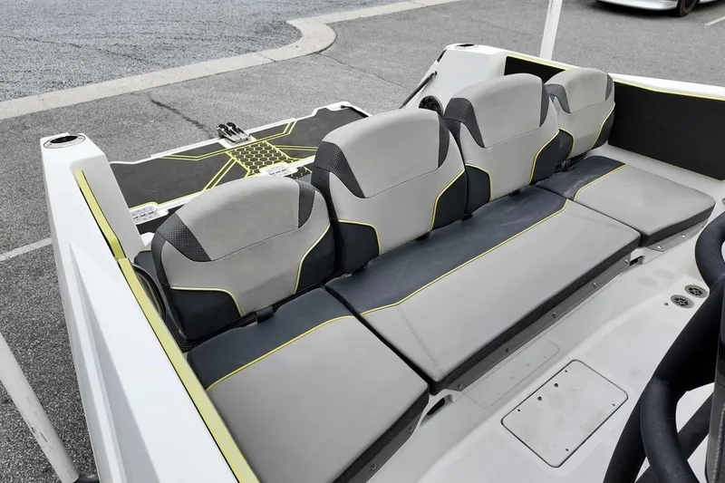 Slide: The Image of 2020 Scarab 255 ID boat interior with gray and black seating, yellow accents. - 13