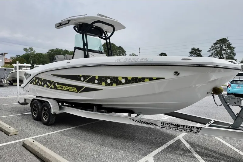 Slide: The Image of 2020 Scarab 255 ID boat on trailer, featuring sleek design and modern graphics. - 3