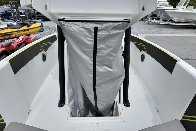 Slide: The Image of 2020 Scarab 255 ID boat interior with storage compartment and protective cover. - 6